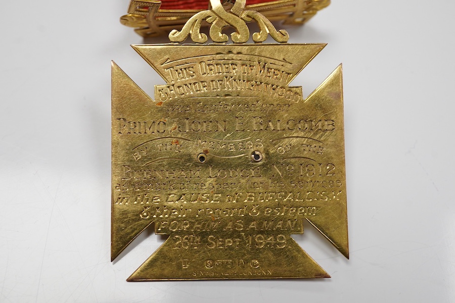 A 9ct gold Masonic 'Royal Order of Antedeluvian Buffaloes' medal, circa 1949, designed as a Maltese cross centring on a buffalo's face with garnet eyes, within a blue enamel garter border, inscribed 'Royal Order of Anted